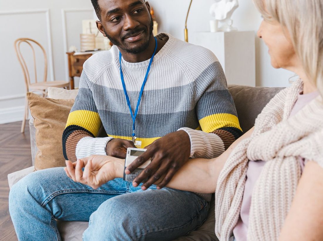 A caregiver talking warmly with a senior woman